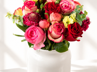 Love Language flower bouquet with roses, solomio, ranunculus, and eucalyptus in a vase