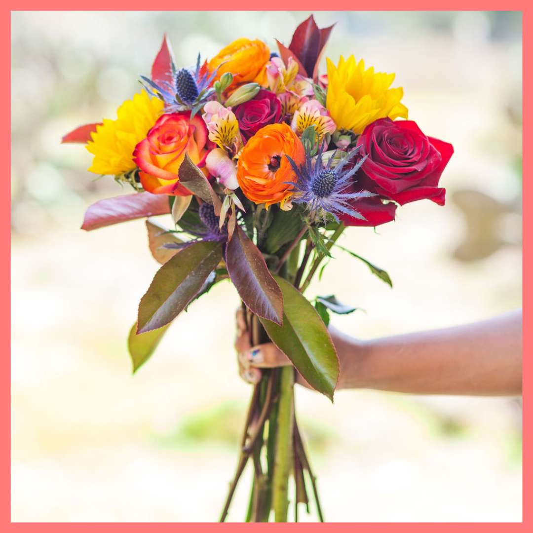 The Pumpkin Nice flower bouquet includes mixed stems of sunflowers, roses, ranunculus, alstroemeria, photinea, and eryngium. Please note that as flowers are a live product, colors and varieties may slightly vary from the photos shown to provide you with the freshest and most beautiful bouquet.