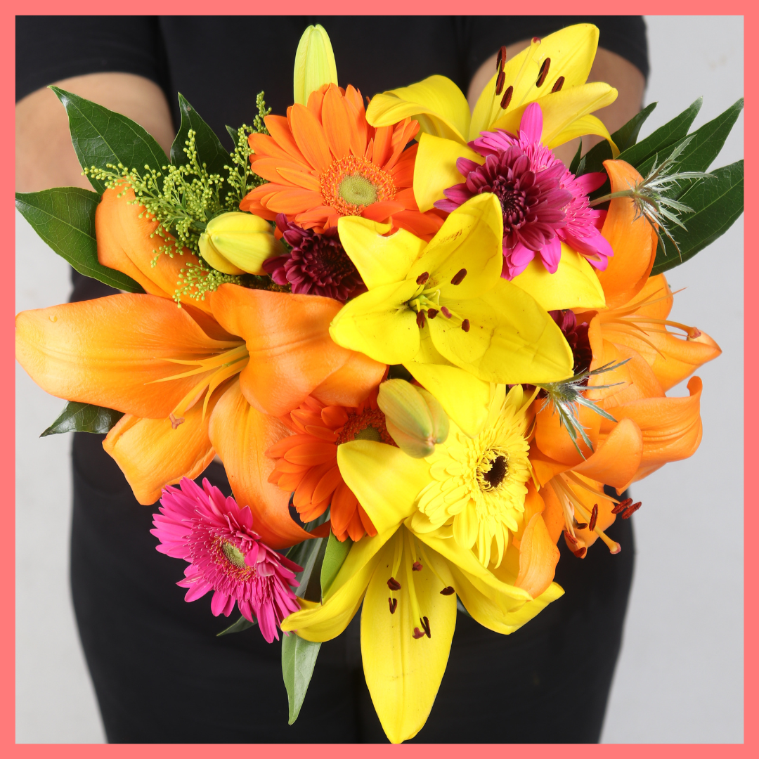 The Autumn Vibes bouquet includes mixed stems of lilies, gerbera daisies, CDN pompoms, eryngium, cocculus, aster, and pittosporum!