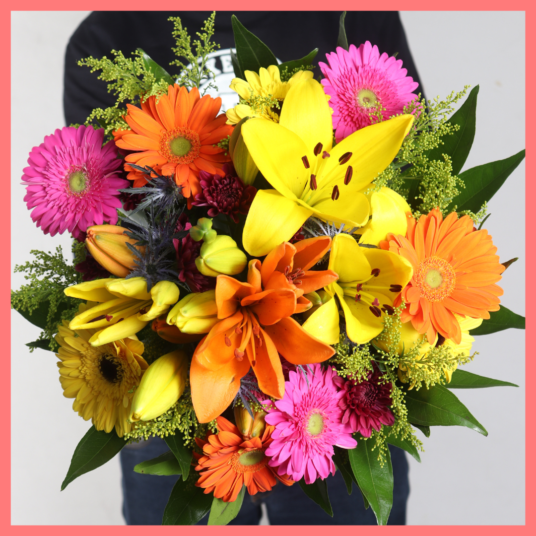The Autumn Vibes bouquet includes mixed stems of lilies, gerbera daisies, CDN pompoms, eryngium, cocculus, aster, and pittosporum!