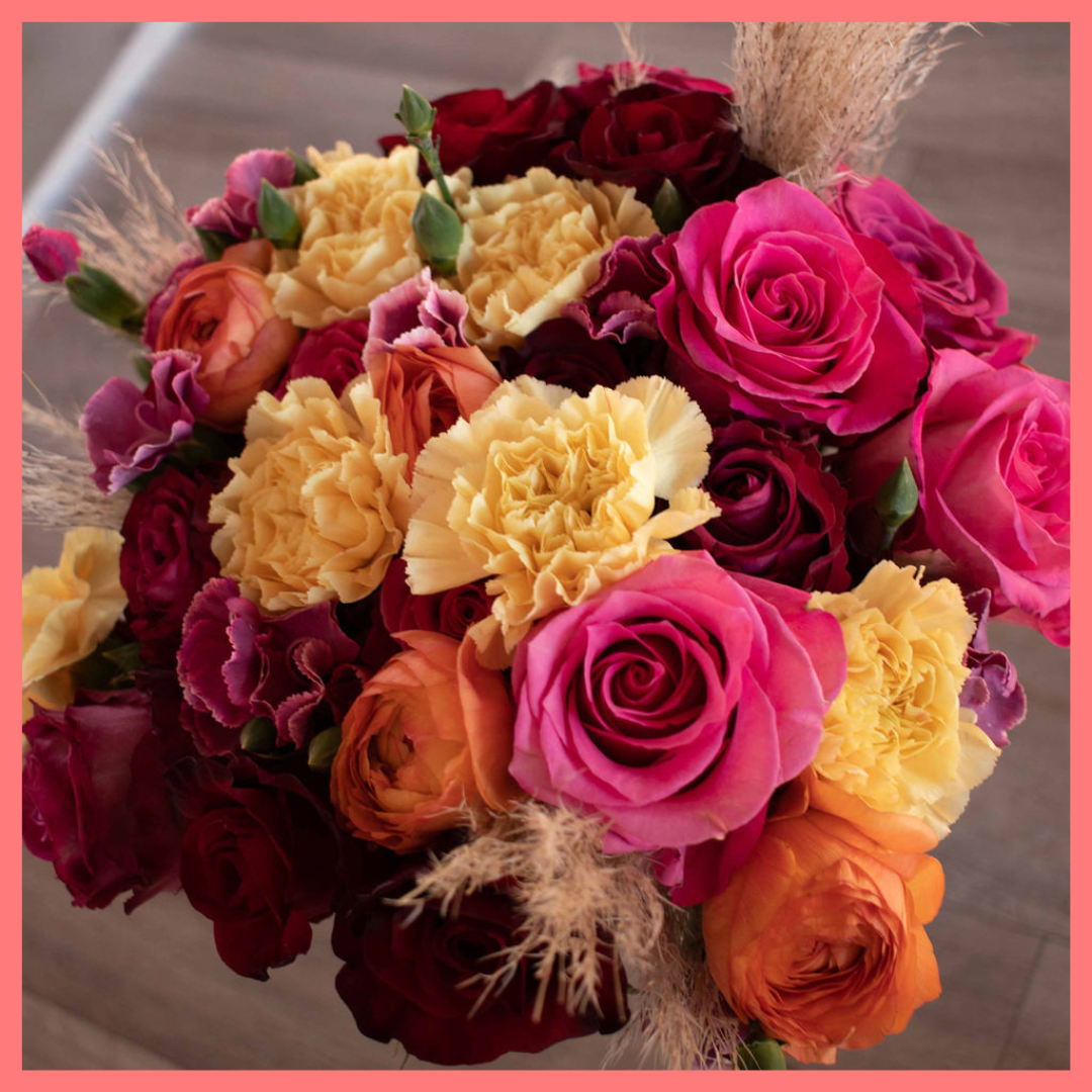 The Family Memories bouquet includes mixed stems of roses, ranunculus, carnation, solomio, and dried pampas!