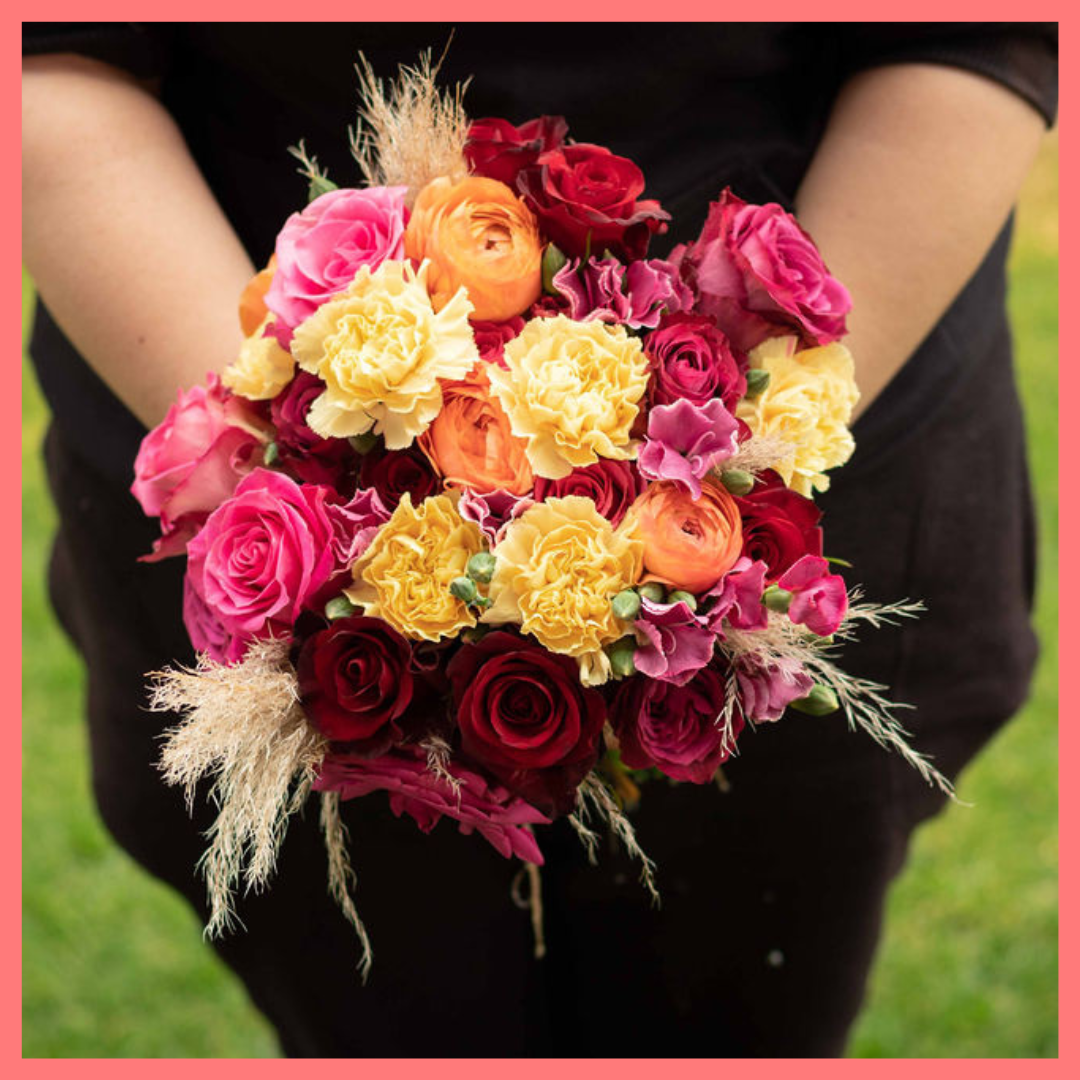 The Family Memories bouquet includes mixed stems of roses, ranunculus, carnation, solomio, and dried pampas!