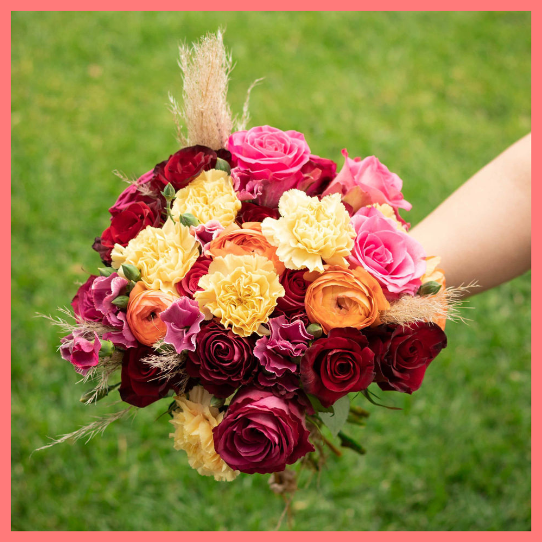 The Family Memories bouquet includes mixed stems of roses, ranunculus, carnation, solomio, and dried pampas!