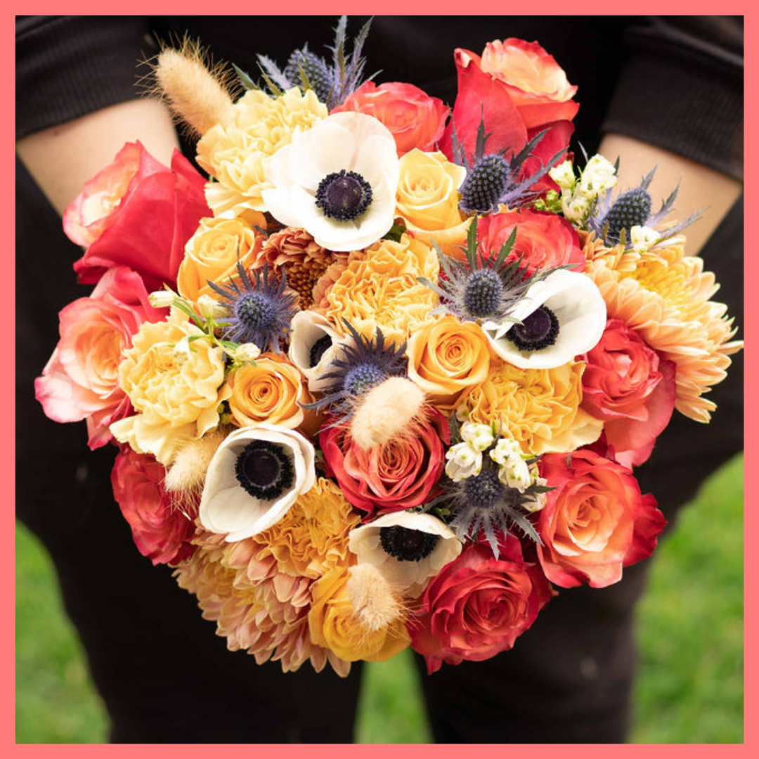 The Harvest Festival bouquet includes mixed stems of roses, anemone, delphinium, eryngium, chrysanthemums, bunny tail, and carnation!