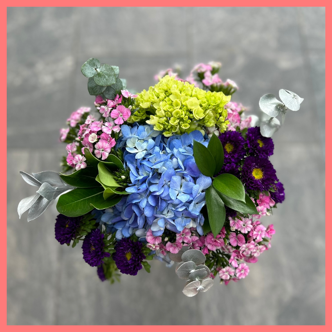 The Holiday Hugs bouquet includes mixed stems of hydrangea, mini hydrangea, matsumoto, dianthus, ruscus, eucalyptus, pittosporum! Please note that as flowers are a live product, colors, and varieties may slightly vary from the photos shown to provide you with the freshest and most beautiful bouquet.