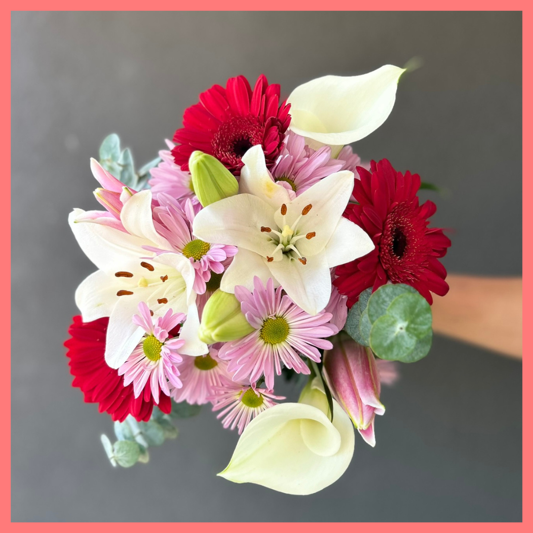 The Oh Hey Cupid bouquet includes mixed stems of lilies, oriental lilies, mini calla lilies, gerbera daisies, pompons, and baby blue eucalyptus! Please note that as flowers are a live product, colors, and varieties may slightly vary from the photos shown to provide you with the freshest and most beautiful bouquet.