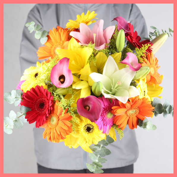 The Summer Breeze bouquet includes mixed stems of eucalyptus, lilies, gerbera daisies, mini calla lilies, and aster! Please note that as flowers are a live product, colors, and varieties may slightly vary from the photos shown to provide you with the freshest and most beautiful bouquet.