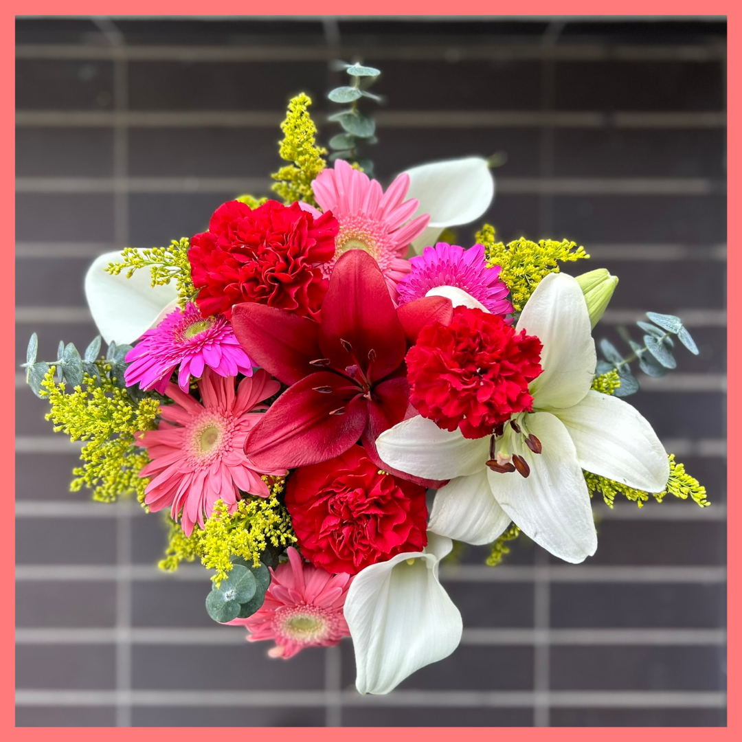 The Xmas Breeze bouquet includes mixed stems of lilies, gerbera daisies, mini callas, carnations, aster, and eucalyptus! Please note that as flowers are a live product, colors, and varieties may slightly vary from the photos shown to provide you with the freshest and most beautiful bouquet.