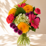 Golden Sunrise flower bouquet with hydrangea, gerbera, and carnations in a vase