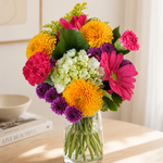 Golden Sunrise flower bouquet on a living room table