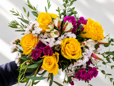 Golden Together flower bouquet with roses, lilliput, statice, alstroemeria, and eucalyptus
