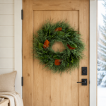 Merry & Bright wreath hanging on a natural wood front door