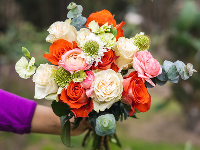 Pretty and Festive flower bouquet with roses, ranunculus, scabiosa, solomio, and eucalyptus