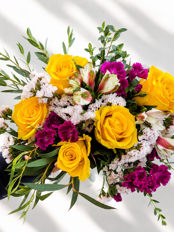 Golden Together flower bouquet with roses, lilliput, statice, alstroemeria, and eucalyptus