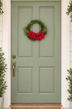 The Cranberry Willow Wreath hanging on a sage green front door