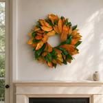 The Grand Magnolia wreath styled above a limestone fireplace mantel