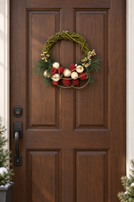 The Jingle Willow Wreath hanging on a dark wood front door
