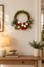 The Jingle Willow Wreath styled on a wall above a console table