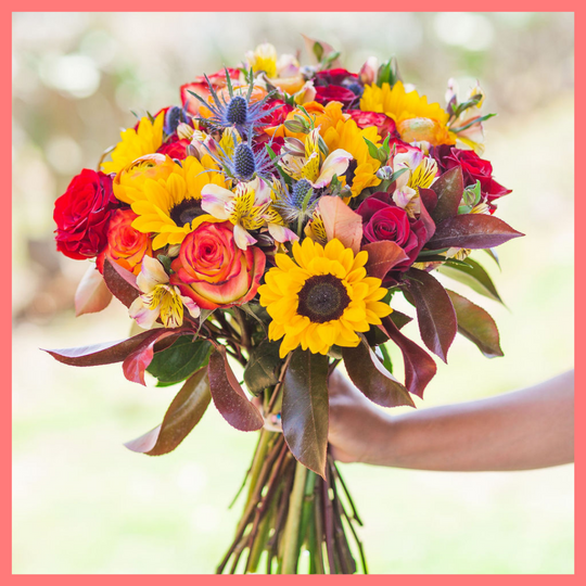 The Pumpkin Nice flower bouquet includes mixed stems of sunflowers, roses, ranunculus, alstroemeria, photinea, and eryngium. Please note that as flowers are a live product, colors and varieties may slightly vary from the photos shown to provide you with the freshest and most beautiful bouquet.