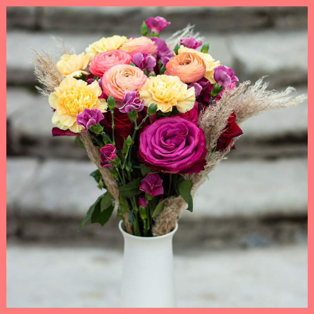 The Family Memories bouquet includes mixed stems of roses, ranunculus, carnation, solomio, and dried pampas! 