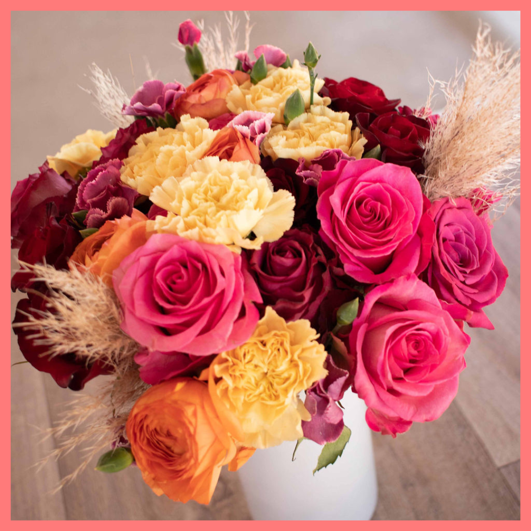 The Family Memories bouquet includes mixed stems of roses, ranunculus, carnation, solomio, and dried pampas!