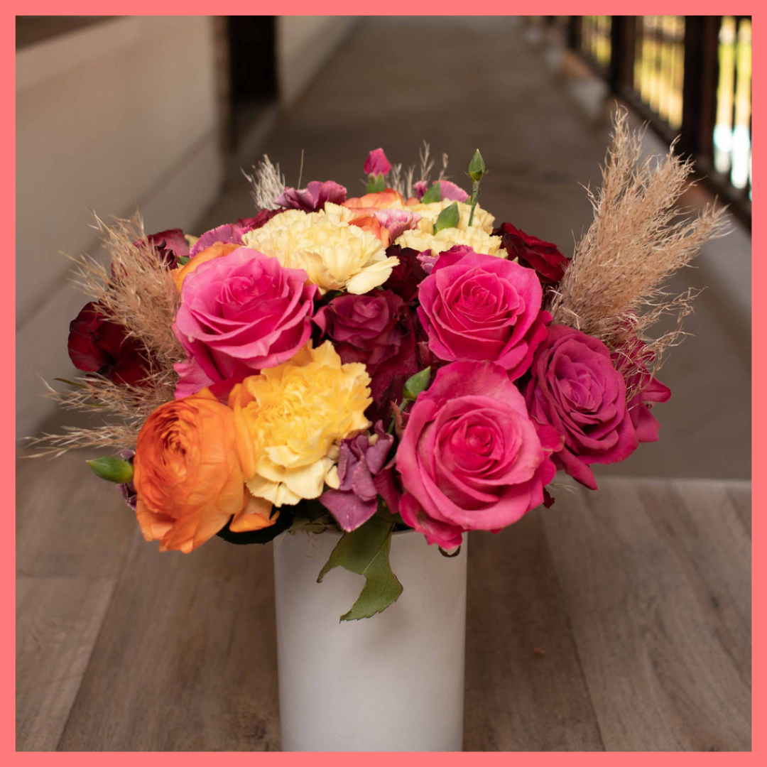 The Family Memories bouquet includes mixed stems of roses, ranunculus, carnation, solomio, and dried pampas!