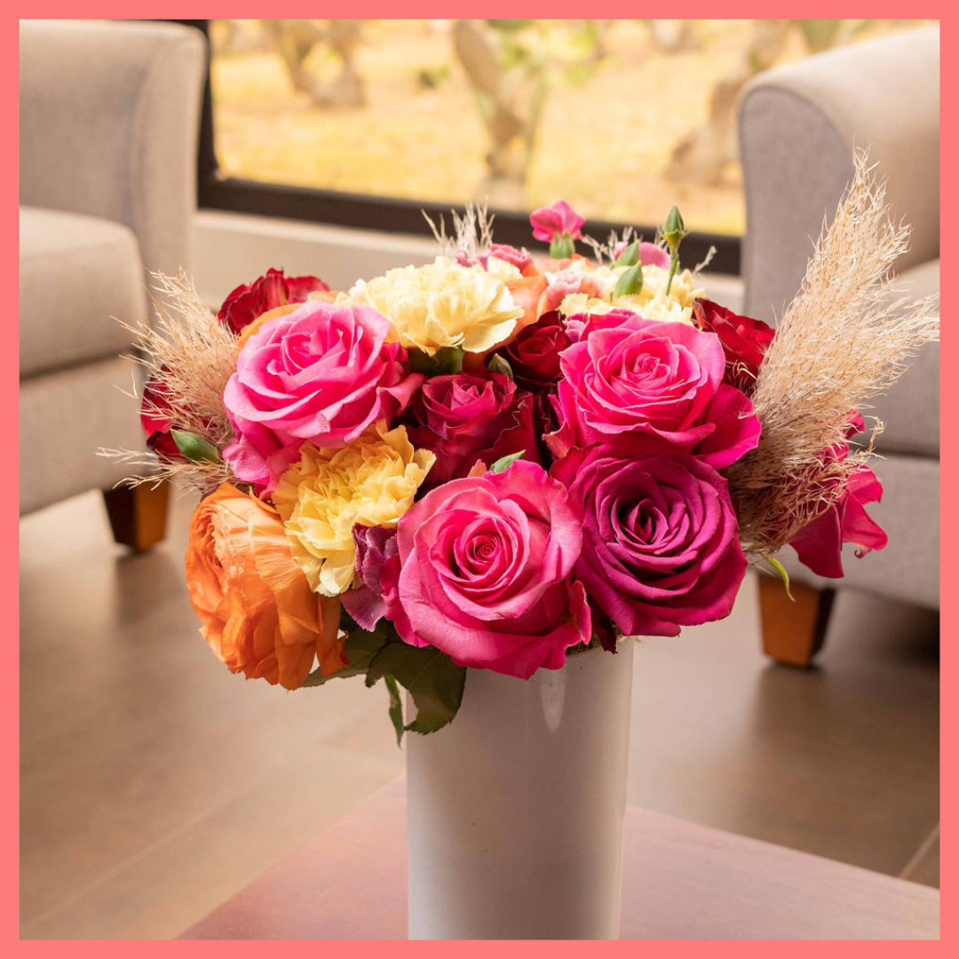 The Family Memories bouquet includes mixed stems of roses, ranunculus, carnation, solomio, and dried pampas!