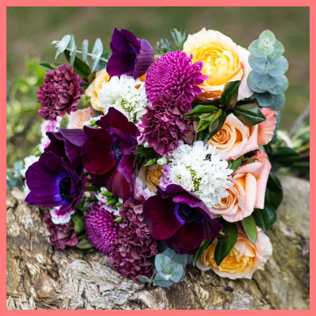 The Farm Days bouquet includes mixed stems of roses, carnation, anemone, scabiosa, hebes, eucalyptus, and chrysanthemums!