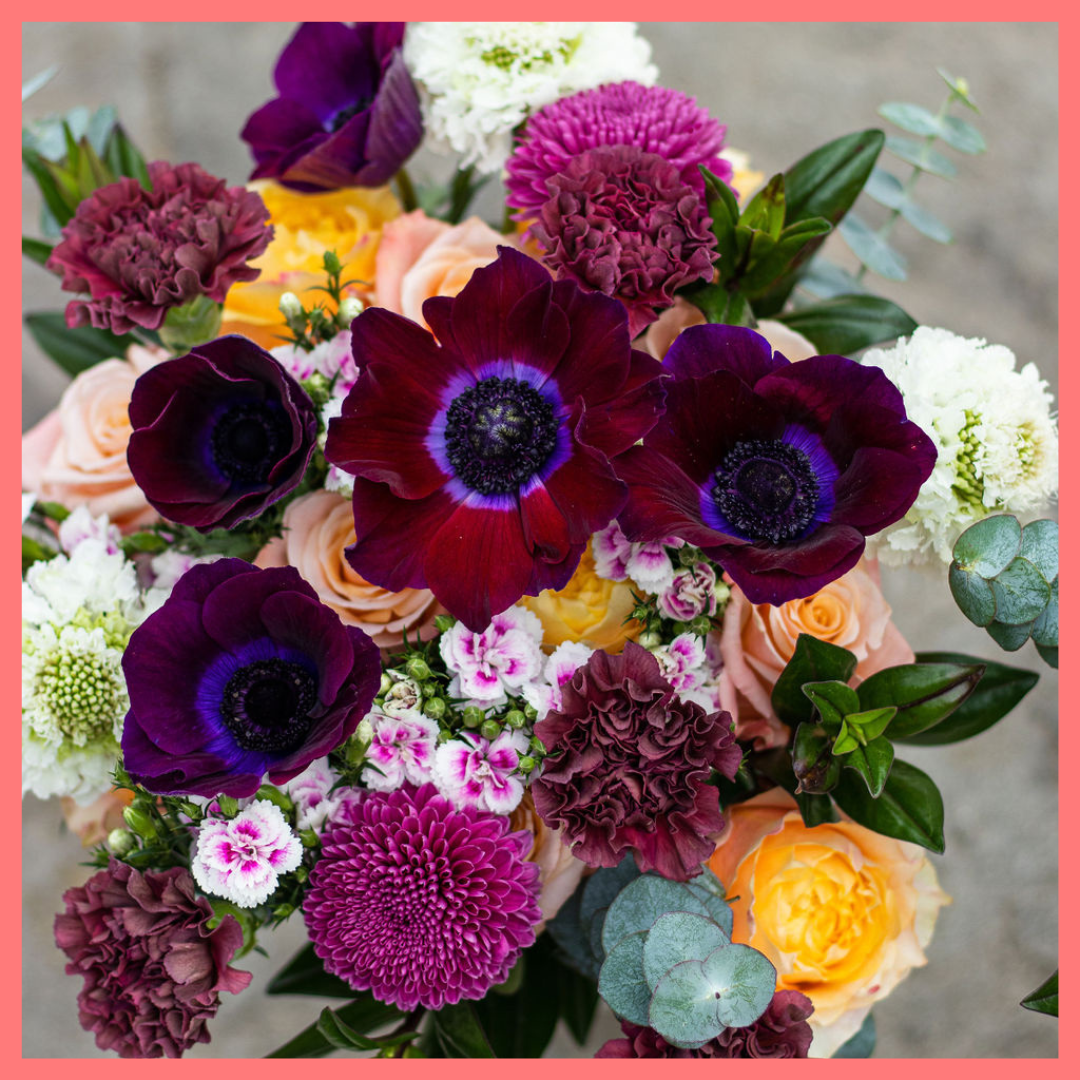 The Farm Days bouquet includes mixed stems of roses, carnation, anemone, scabiosa, hebes, eucalyptus, and chrysanthemums!