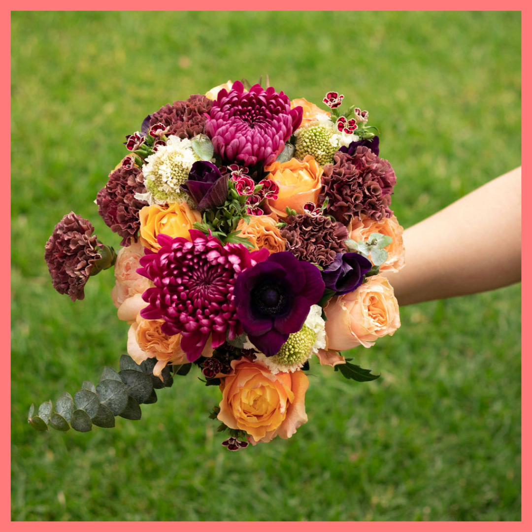 The Farm Days bouquet includes mixed stems of roses, carnation, anemone, scabiosa, hebes, eucalyptus, and chrysanthemums!