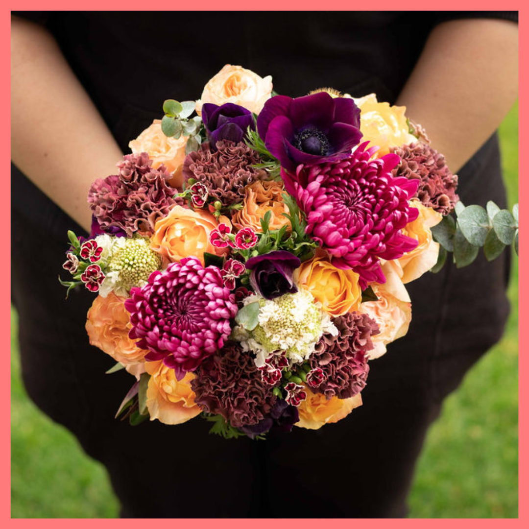 The Farm Days bouquet includes mixed stems of roses, carnation, anemone, scabiosa, hebes, eucalyptus, and chrysanthemums!