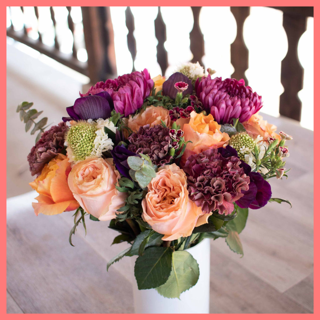 The Farm Days bouquet includes mixed stems of roses, carnation, anemone, scabiosa, hebes, eucalyptus, and chrysanthemums!