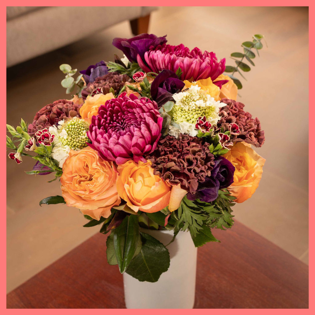 The Farm Days bouquet includes mixed stems of roses, carnation, anemone, scabiosa, hebes, eucalyptus, and chrysanthemums!