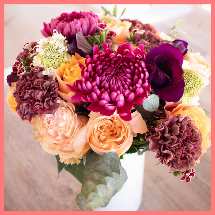 The Farm Days bouquet includes mixed stems of roses, carnation, anemone, scabiosa, hebes, eucalyptus, and chrysanthemums!