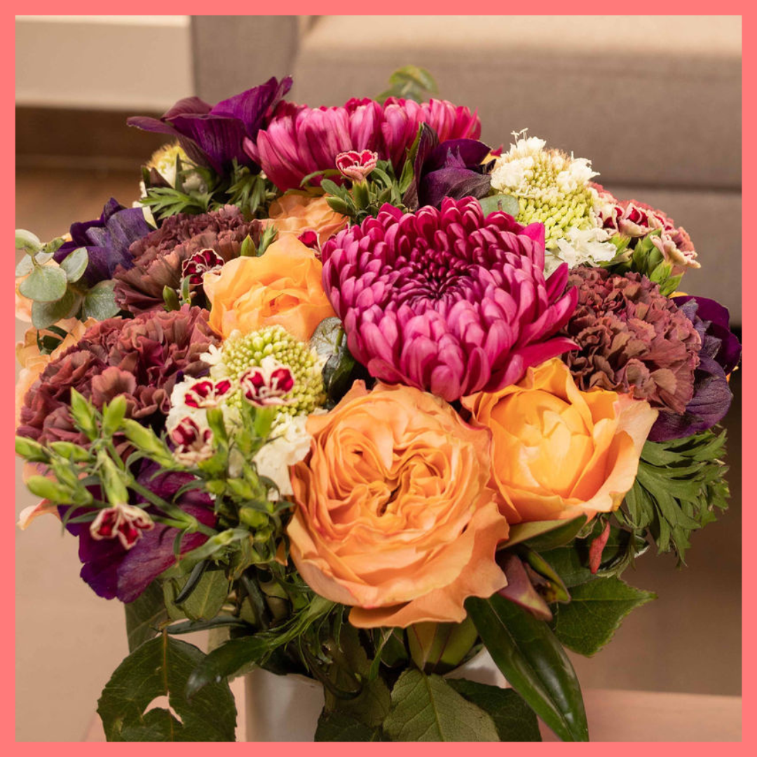 The Farm Days bouquet includes mixed stems of roses, carnation, anemone, scabiosa, hebes, eucalyptus, and chrysanthemums!