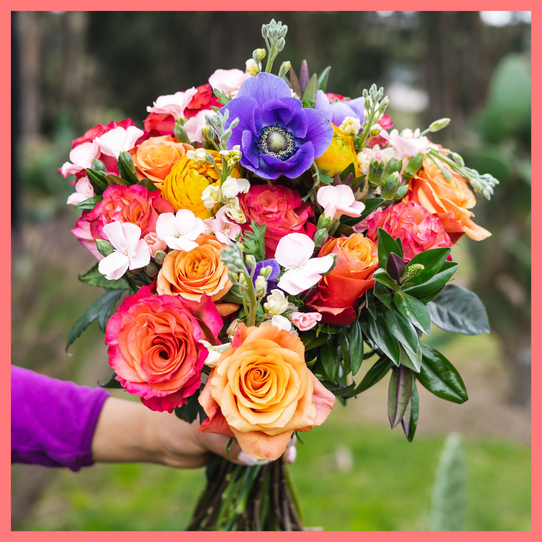 The Feast Your Eyes flower bouquet includes mixed stems of anemones, ranunculus, solomio, stock, hebes, and roses. Please note that as flowers are a live product, colors and varieties may slightly vary from the photos shown to provide you with the freshest and most beautiful bouquet.