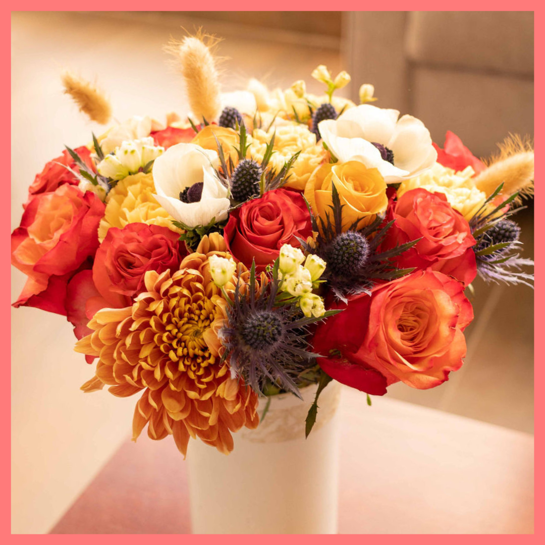 The Harvest Festival bouquet includes mixed stems of roses, anemone, delphinium, eryngium, chrysanthemums, bunny tail, and carnation!