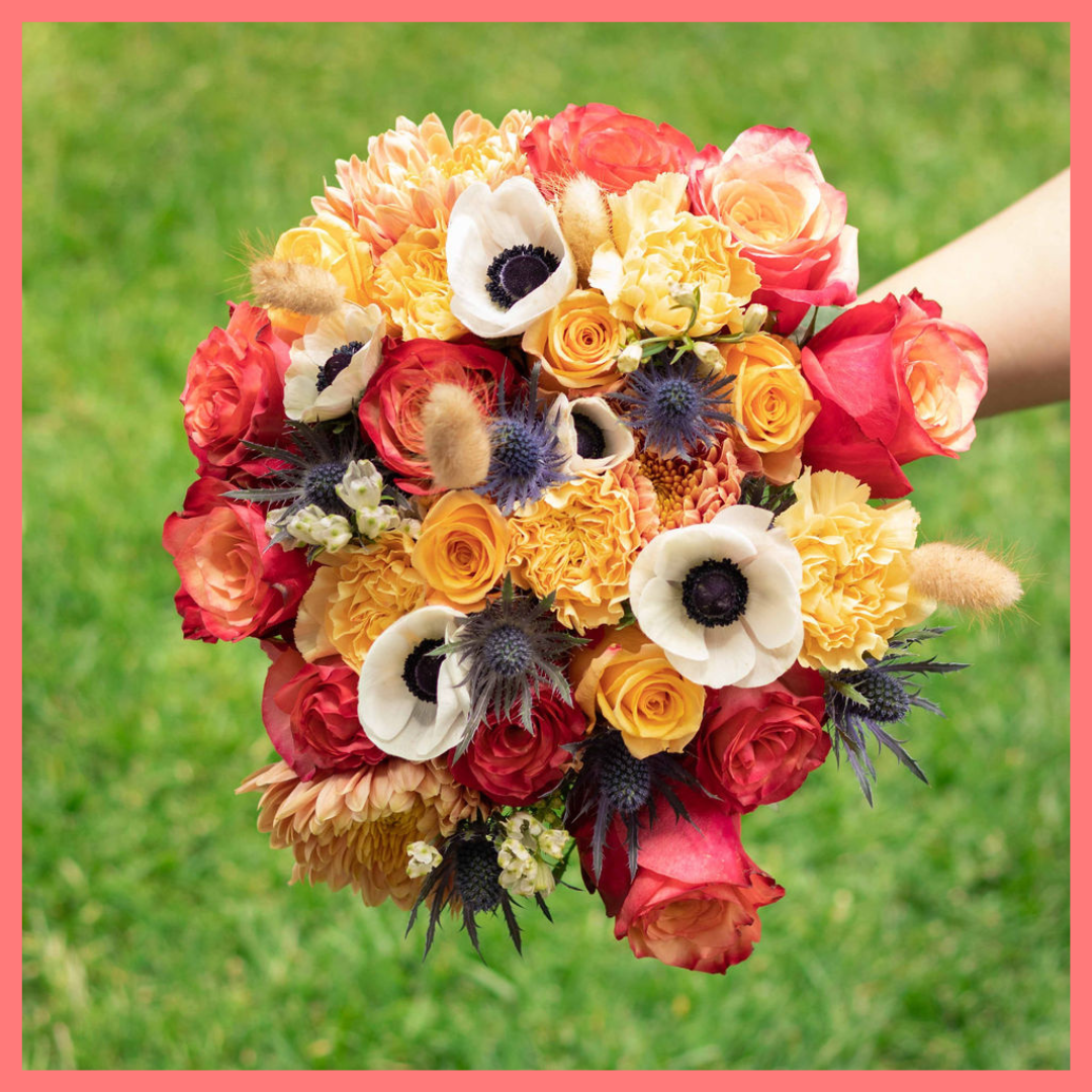 The Harvest Festival bouquet includes mixed stems of roses, anemone, delphinium, eryngium, chrysanthemums, bunny tail, and carnation!