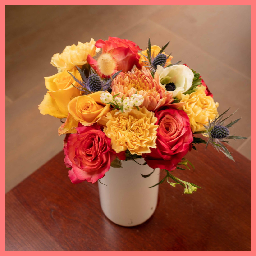 The Harvest Festival bouquet includes mixed stems of roses, anemone, delphinium, eryngium, chrysanthemums, bunny tail, and carnation!