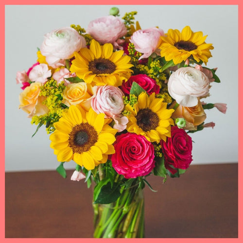 Order the Here Comes The Sun(flower) flower bouquet! The Here Comes The Sun(flower) bouquet includes mixed stems of sunflowers, ranunculus, roses, solomio, and solidago.The flowers will be shipped directly from the farm to you!