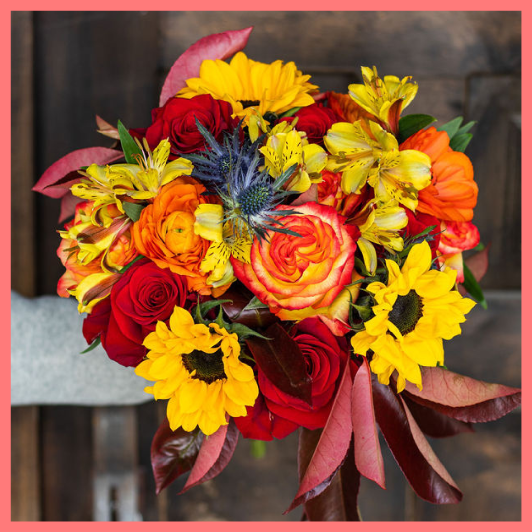 The Pumpkin Nice bouquet includes mixed stems of sunflowers, ranunculus, roses, alstroemeria, photinea, and eryngium. Please note that as flowers are a live product, colors and varieties may slightly vary from the photos shown to provide you with the freshest and most beautiful bouquet.
