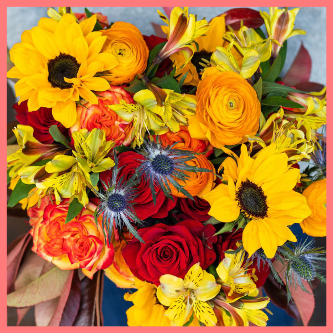 The Pumpkin Nice bouquet includes mixed stems of sunflowers, ranunculus, roses, alstroemeria, photinea, and eryngium. Please note that as flowers are a live product, colors and varieties may slightly vary from the photos shown to provide you with the freshest and most beautiful bouquet.