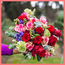 Load image into Gallery viewer, The Growers&#39; Choice - Christmas Flower Bouquet includes mixed stems of lilies, calla lilies, gerbera daisies, hypericum, schlefflera, chrysanthemums, and eryngium. Please note that as flowers are a live product, colors and varieties may slightly vary from the photos shown to provide you with the freshest and most beautiful bouquet.
