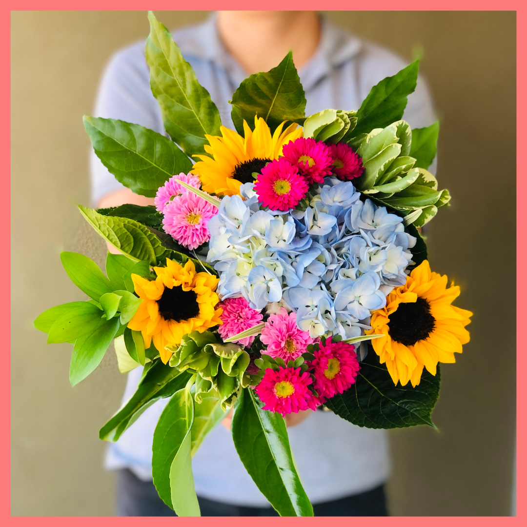 The You Blue My Mind bouquet includes mixed stems of sunflowers, hydrangea, matsumoto, ruscus, viburnum, lily grass, aralia, and pittosporum! Please note that as flowers are a live product, colors, and varieties may slightly vary from the photos shown to provide you with the freshest and most beautiful bouquet.