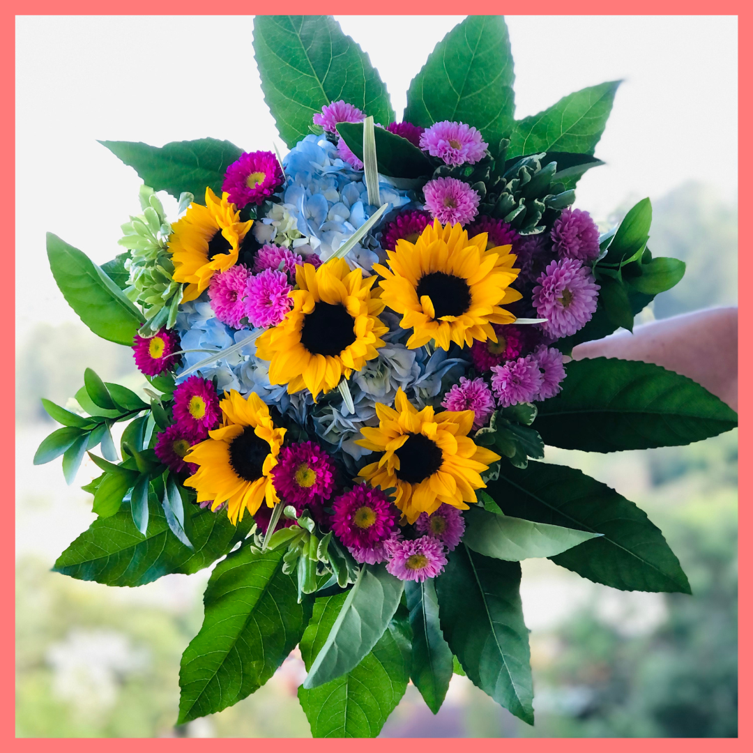 The You Blue My Mind bouquet includes mixed stems of sunflowers, hydrangea, matsumoto, ruscus, viburnum, lily grass, aralia, and pittosporum! Please note that as flowers are a live product, colors, and varieties may slightly vary from the photos shown to provide you with the freshest and most beautiful bouquet.