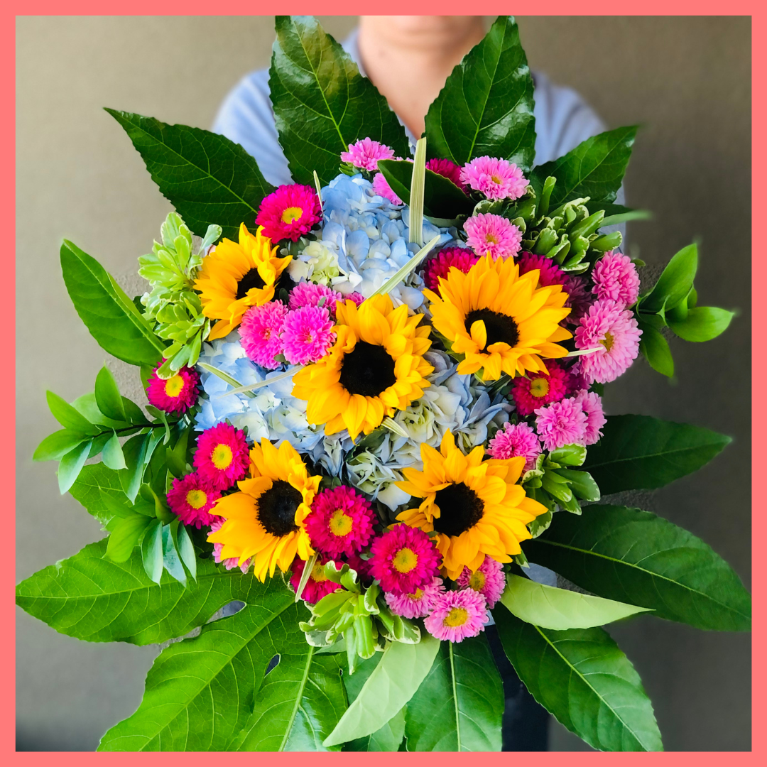 The You Blue My Mind bouquet includes mixed stems of sunflowers, hydrangea, matsumoto, ruscus, viburnum, lily grass, aralia, and pittosporum! Please note that as flowers are a live product, colors, and varieties may slightly vary from the photos shown to provide you with the freshest and most beautiful bouquet.