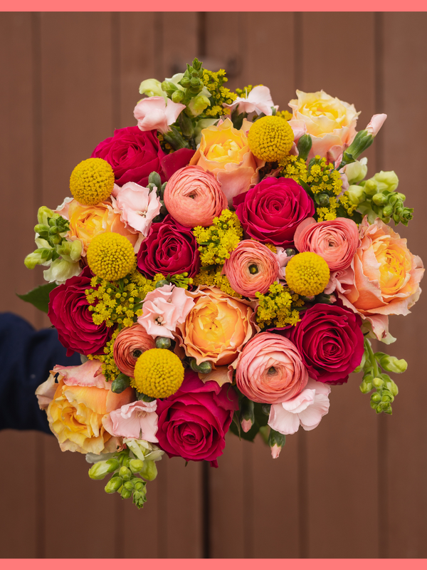 Order the My Dear flower bouquet. The My Dear bouquet includes mixed stems of ranunculus, roses, solidago, snapdragons, solomio, and craspedia. Vase included. The flowers will be shipped directly from the farm to you!