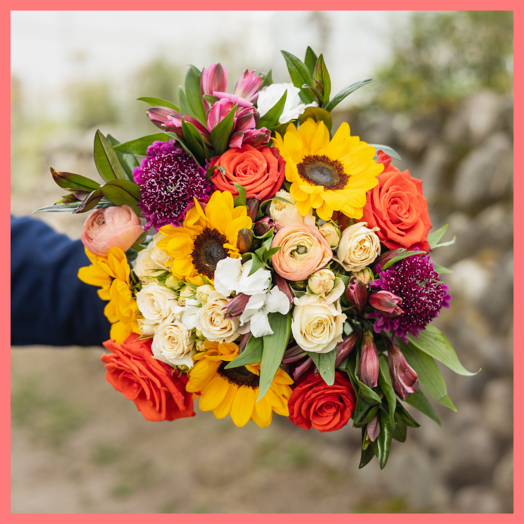 The Sunkissed bouquet includes mixed stems of ranunculus, sunflowers, roses, spray roses, alstroemeria, solomio, scabiosa, and hebes. Scabiosa only included in Lux and Premier sizes. Please note that as flowers are a live product, colors and varieties may slightly vary from the photos shown to provide you with the freshest and most beautiful bouquet.