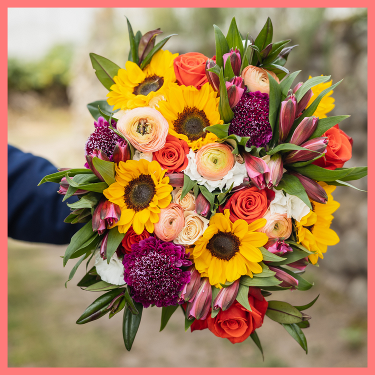 The Sunkissed bouquet includes mixed stems of ranunculus, sunflowers, roses, spray roses, alstroemeria, solomio, scabiosa, and hebes. Scabiosa only included in Lux and Premier sizes. Please note that as flowers are a live product, colors and varieties may slightly vary from the photos shown to provide you with the freshest and most beautiful bouquet.
